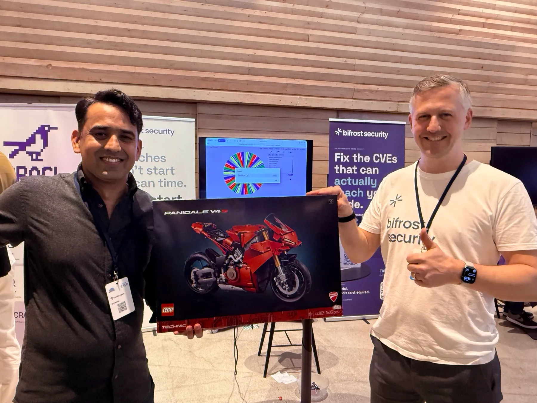 The winner of the bifrost booth survey holding the LEGO Ducati prize.